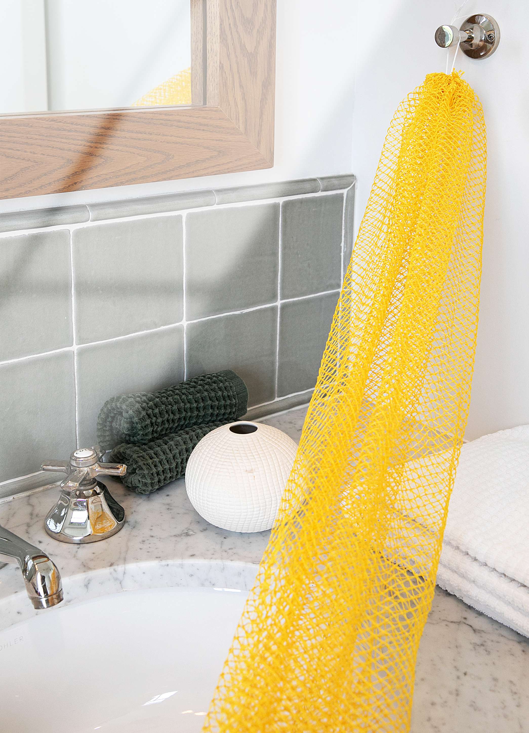 Bellanomi African Exfoliating Net sponge hanging dry in the bathroom.