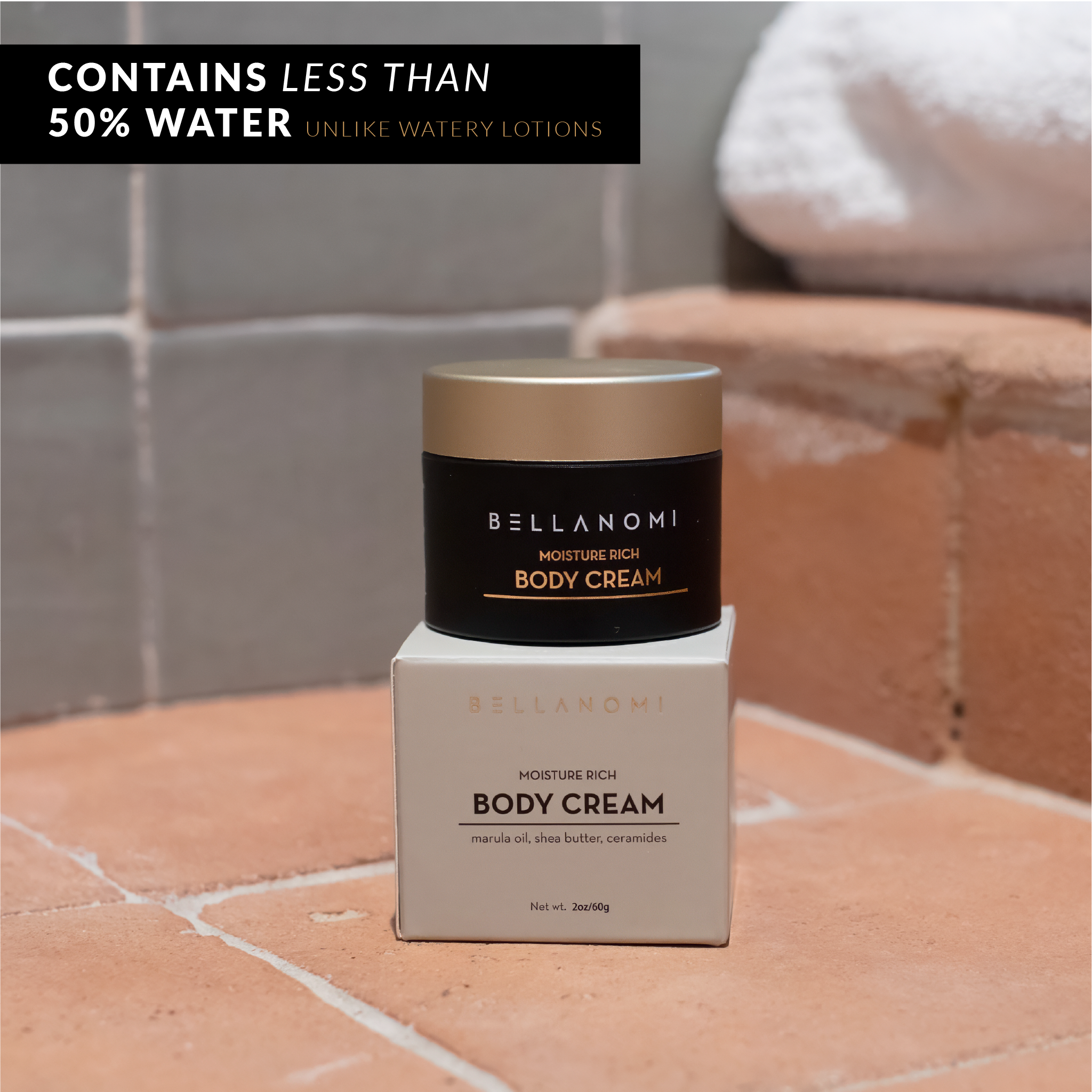 Bellanomi body cream jar and box on a tiled surface with text about water content.