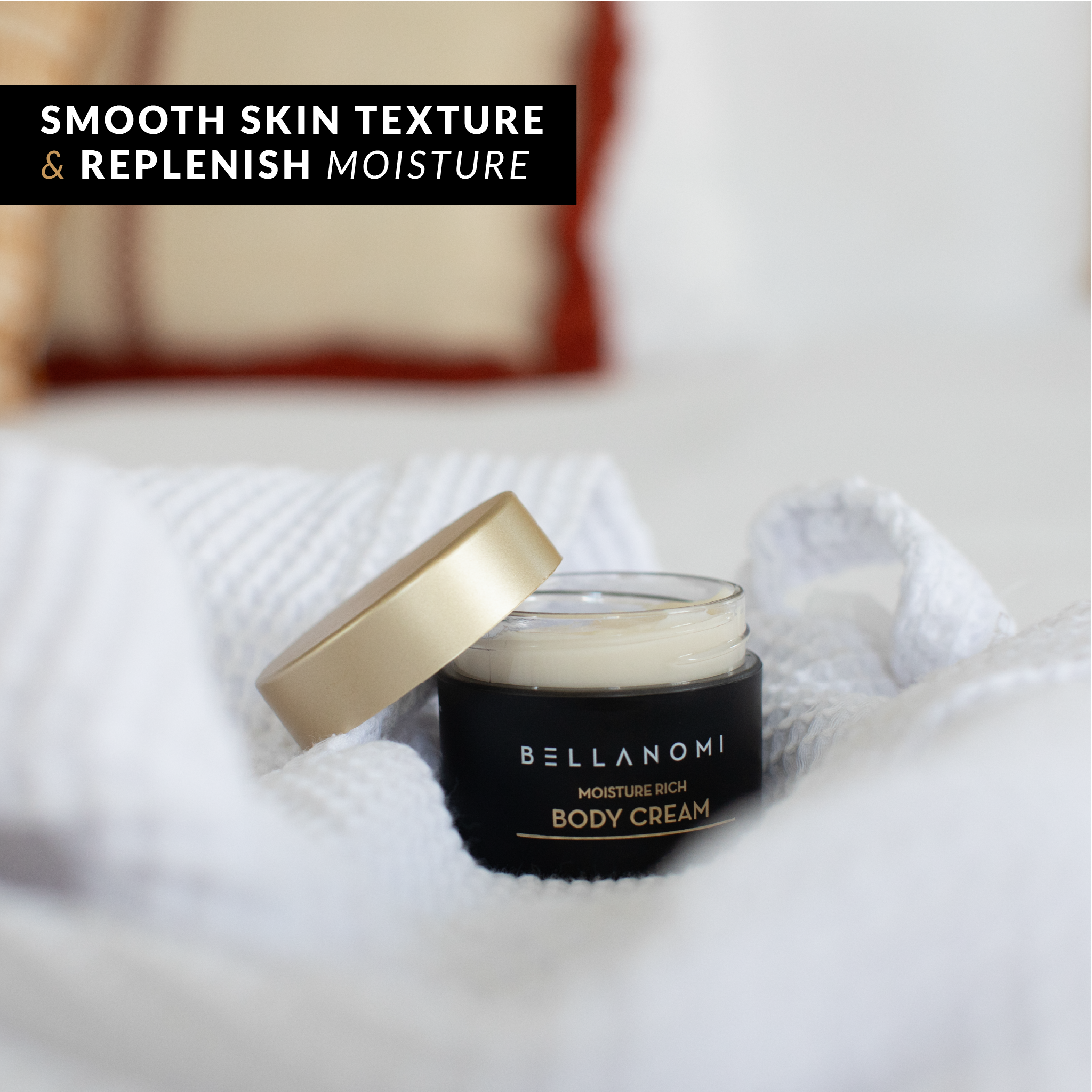 Bellanomi body cream jar on a white blanket with text &