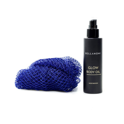Bellanomi Glow Body Oil bottle with a blue net sponge on a white background